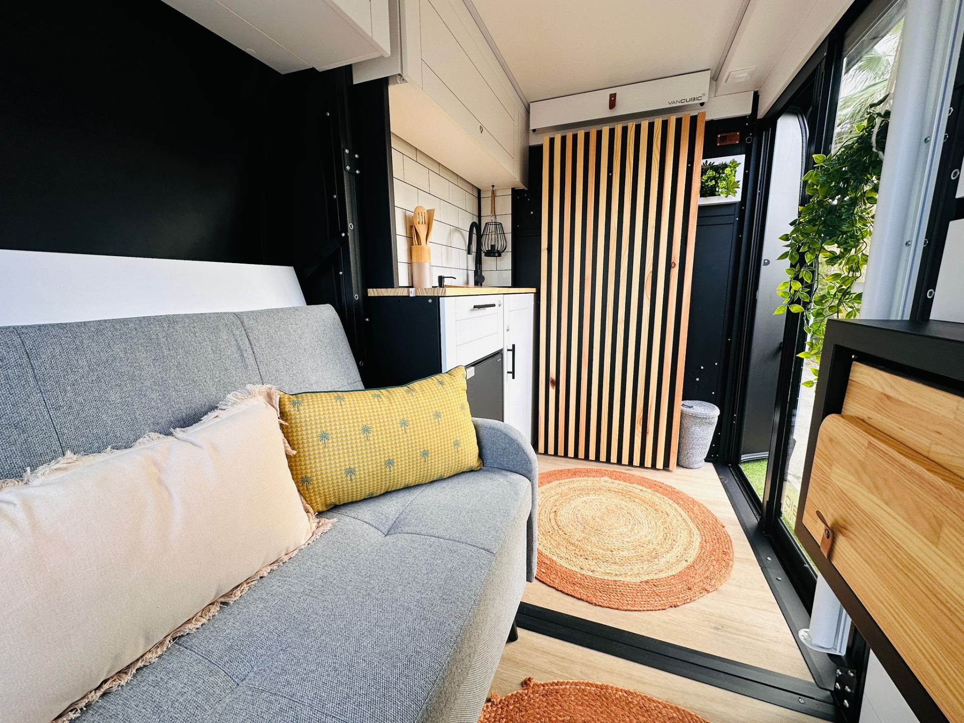Camper van living area with sofa and decor